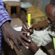 An official at the polling station put an ink mark on a Masai finger after he cased his vote.